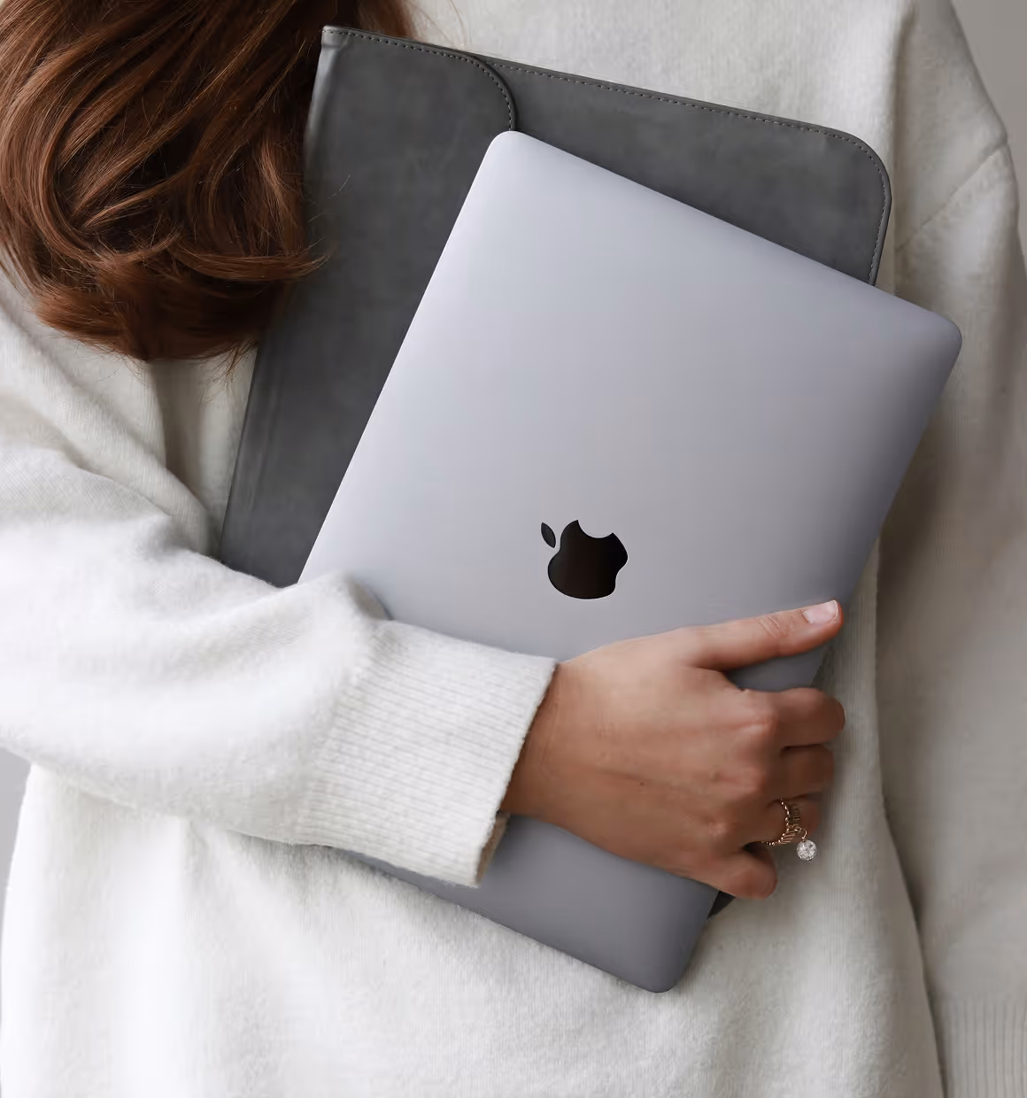 Girl in white dress holding laptop on his hand.