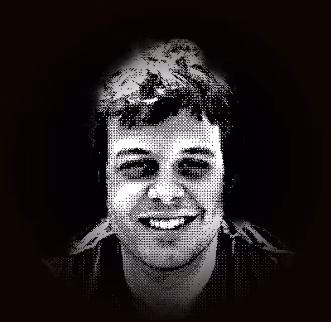 Black and white halftone portrait of a smiling man with short hair against a dark background.
