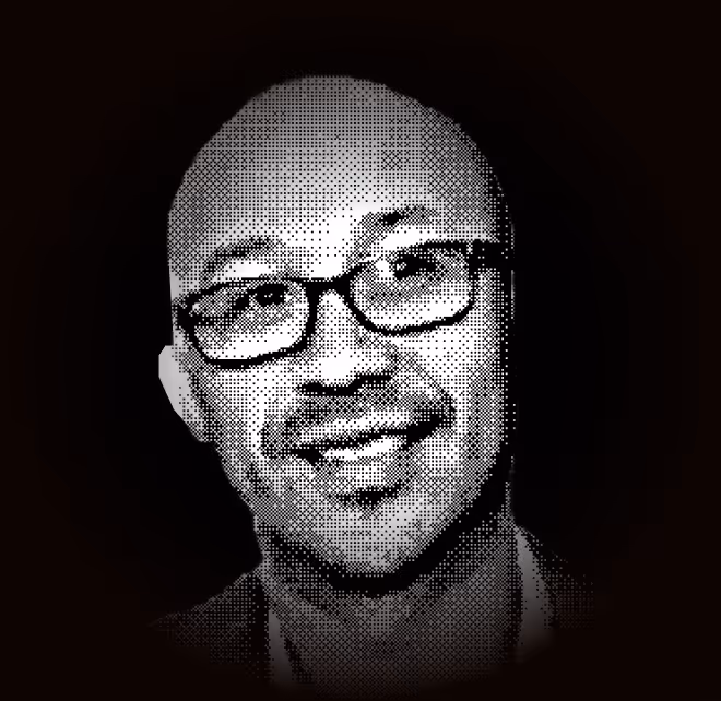 Portrait of a man wearing glasses with a smiling expression in a halftone black and white style.