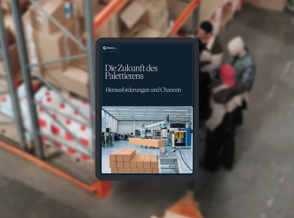 Whitepaper-Mockup mit dem Titel „Die Zukunft des Palettierens - Herausforderungen und Chancen“. Hintergrundbild in einer industriellen Umgebung.