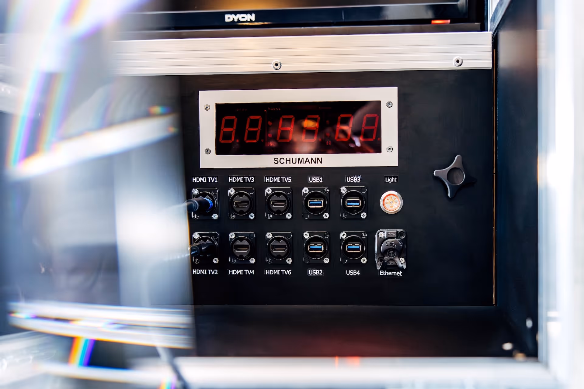 Black control panel labeled SCHUMANN with digital red LED display and ports for HDMI TV, USB, and Ethernet connections.