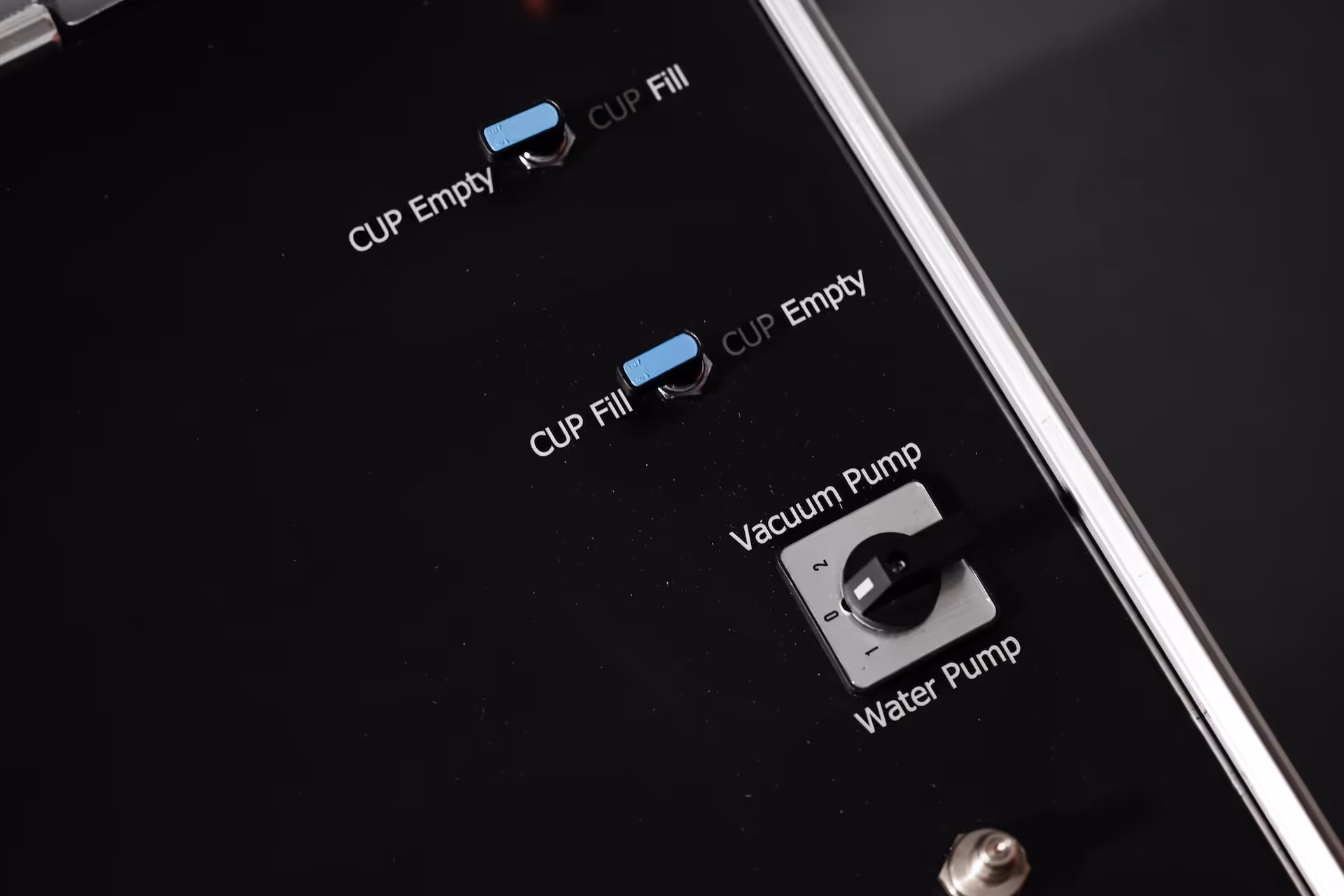 Control panel with blue toggle switches labeled 'Cup Empty', 'Cup Fill', and a rotary switch labeled 'Vacuum Pump' and 'Water Pump' with numbered settings.