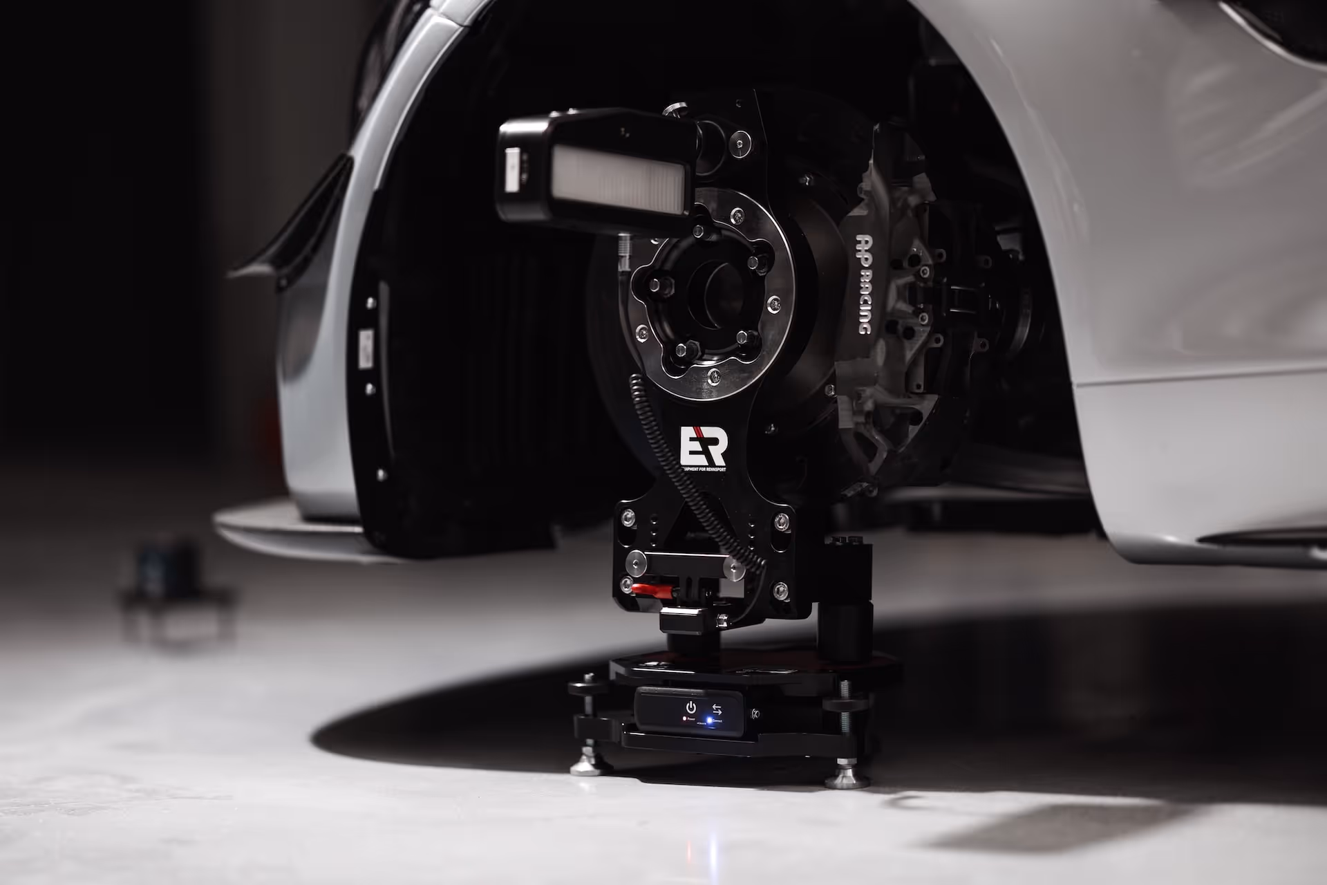 Close-up of a car wheel hub with the wheel alignment system Pro mounted.