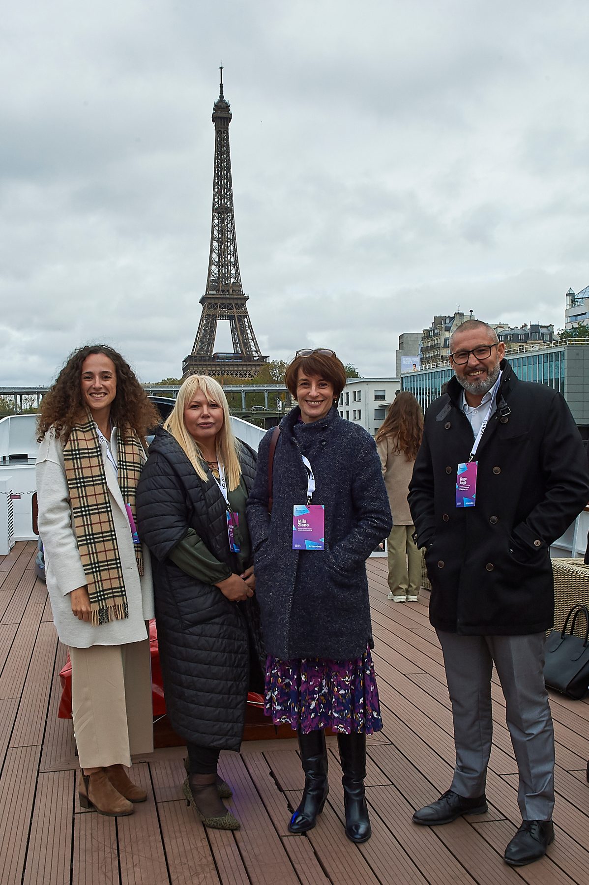Delegates on the deck of the conference venue with the Eiffel Tower behind them