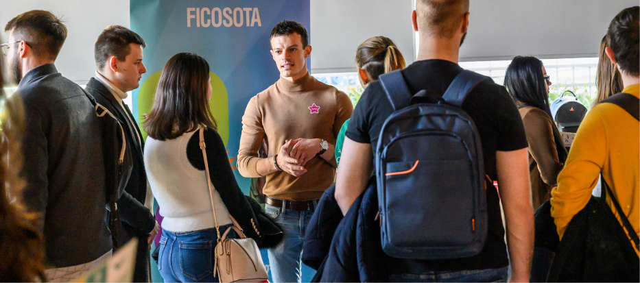 Black and white photograph of people interacting at a table.