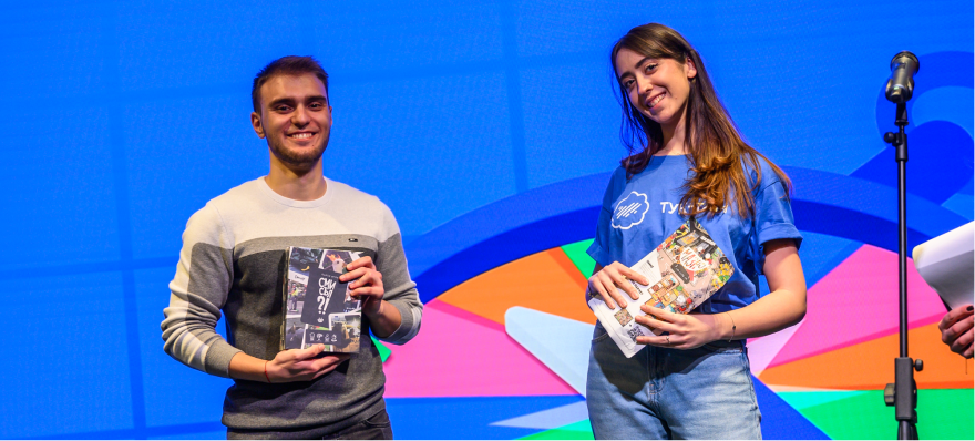 Black and white photograph of people at an event, some holding items.