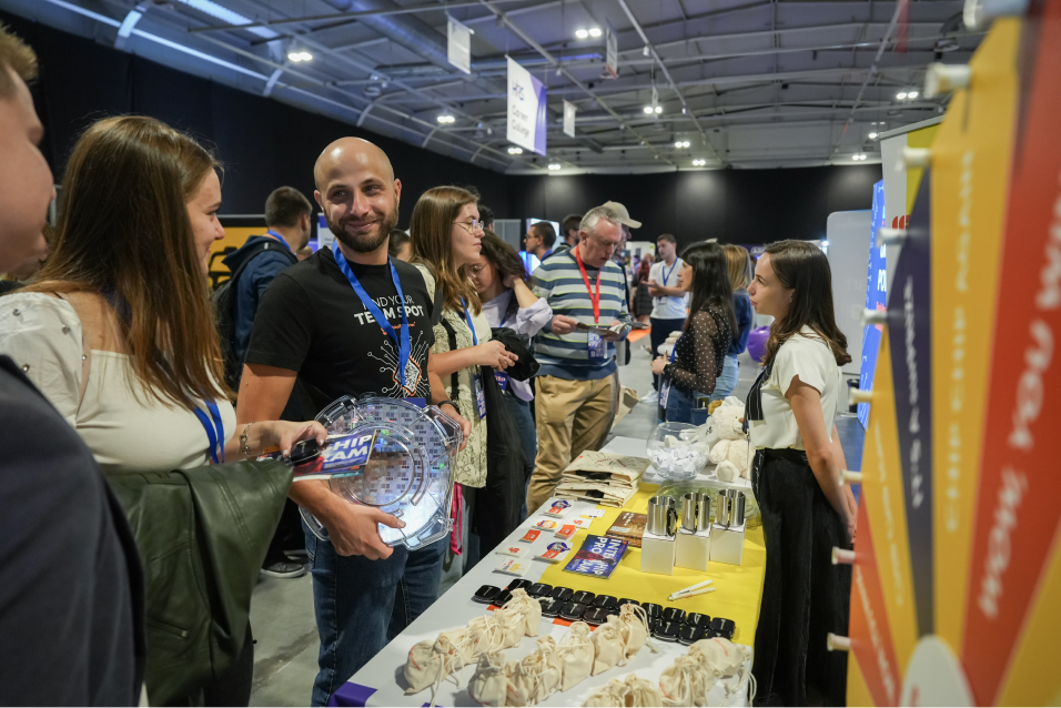 Medium shot photograph of two individuals seated, engaged in a discussion.