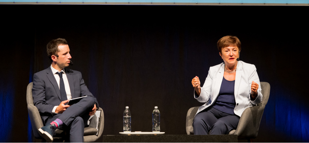 Medium shot photograph of people at a table with awards and items.