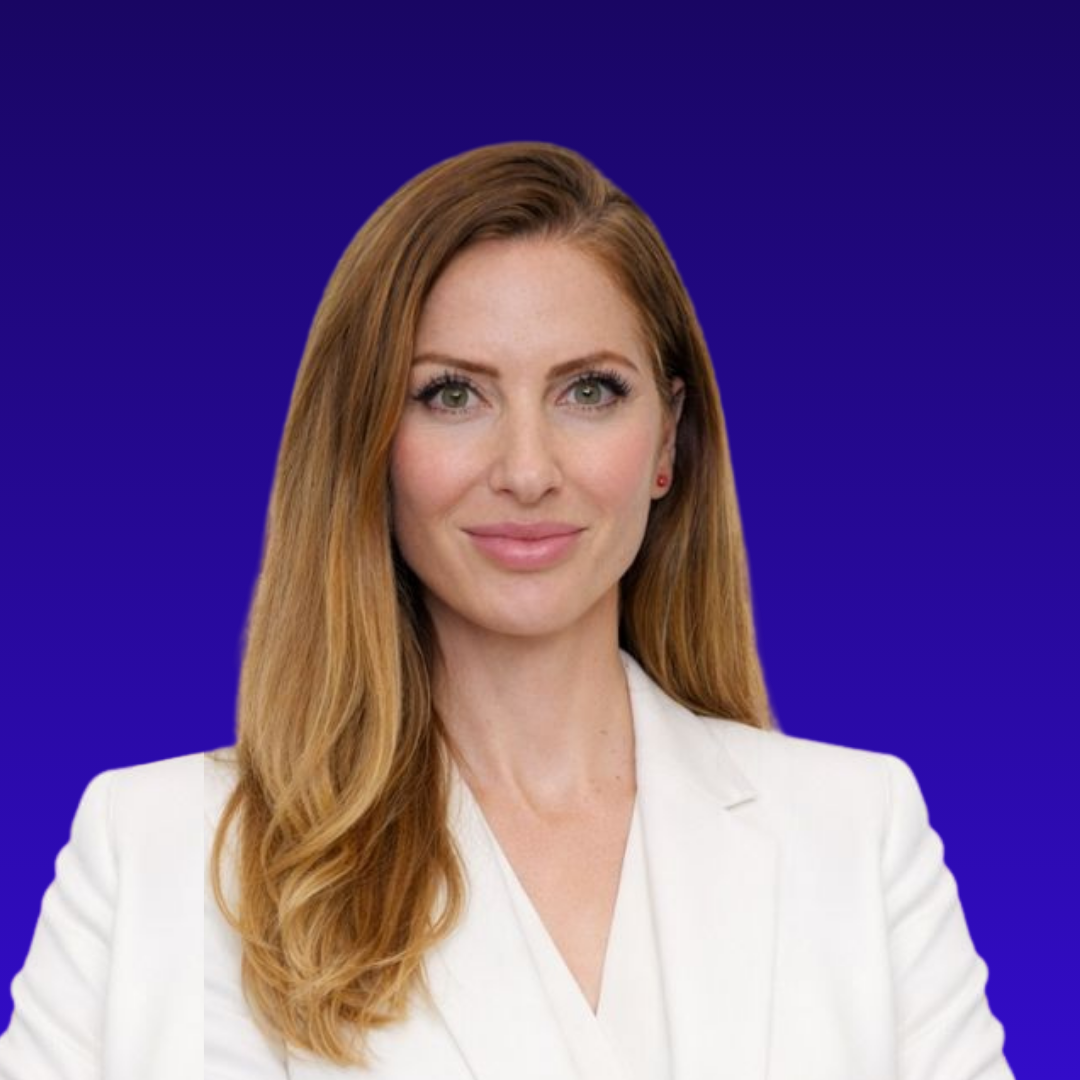 Woman with long light brown hair wearing a white blazer against a blue gradient background.