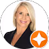 Smiling woman with blonde hair wearing a black top against a white background with an orange star icon. - Total Quality Lending Images