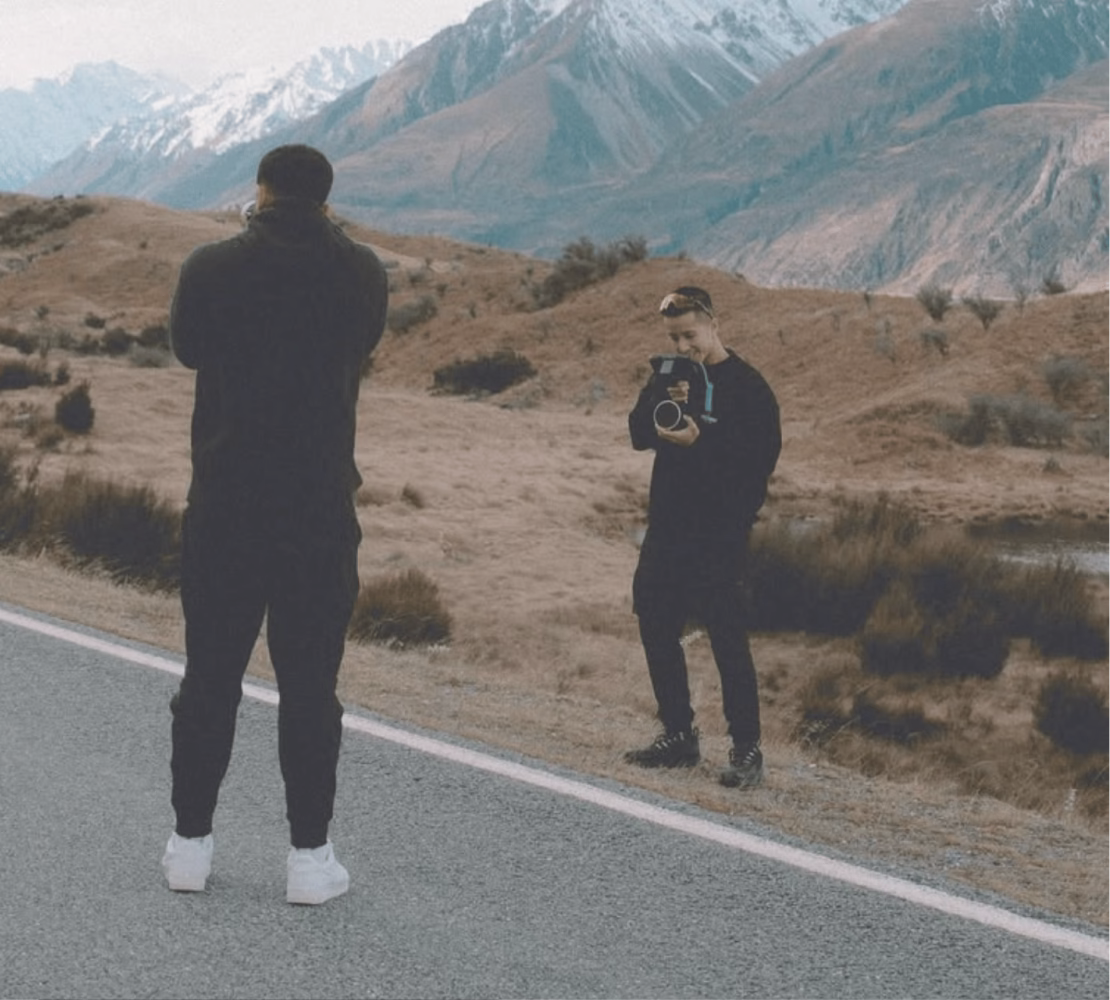 two people standing on a road