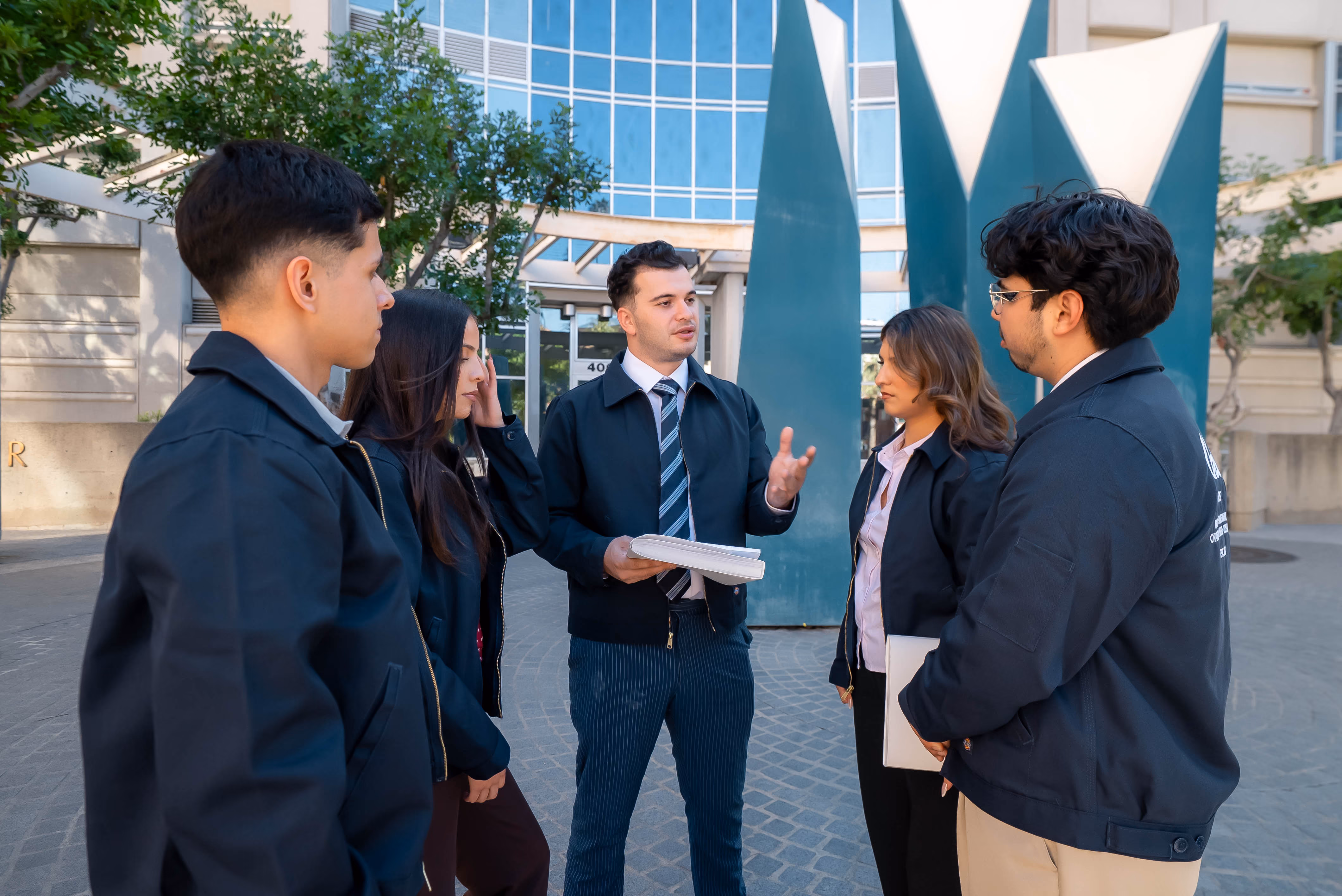 OnCall Bail Bonds team discussing a case outside the courthouse