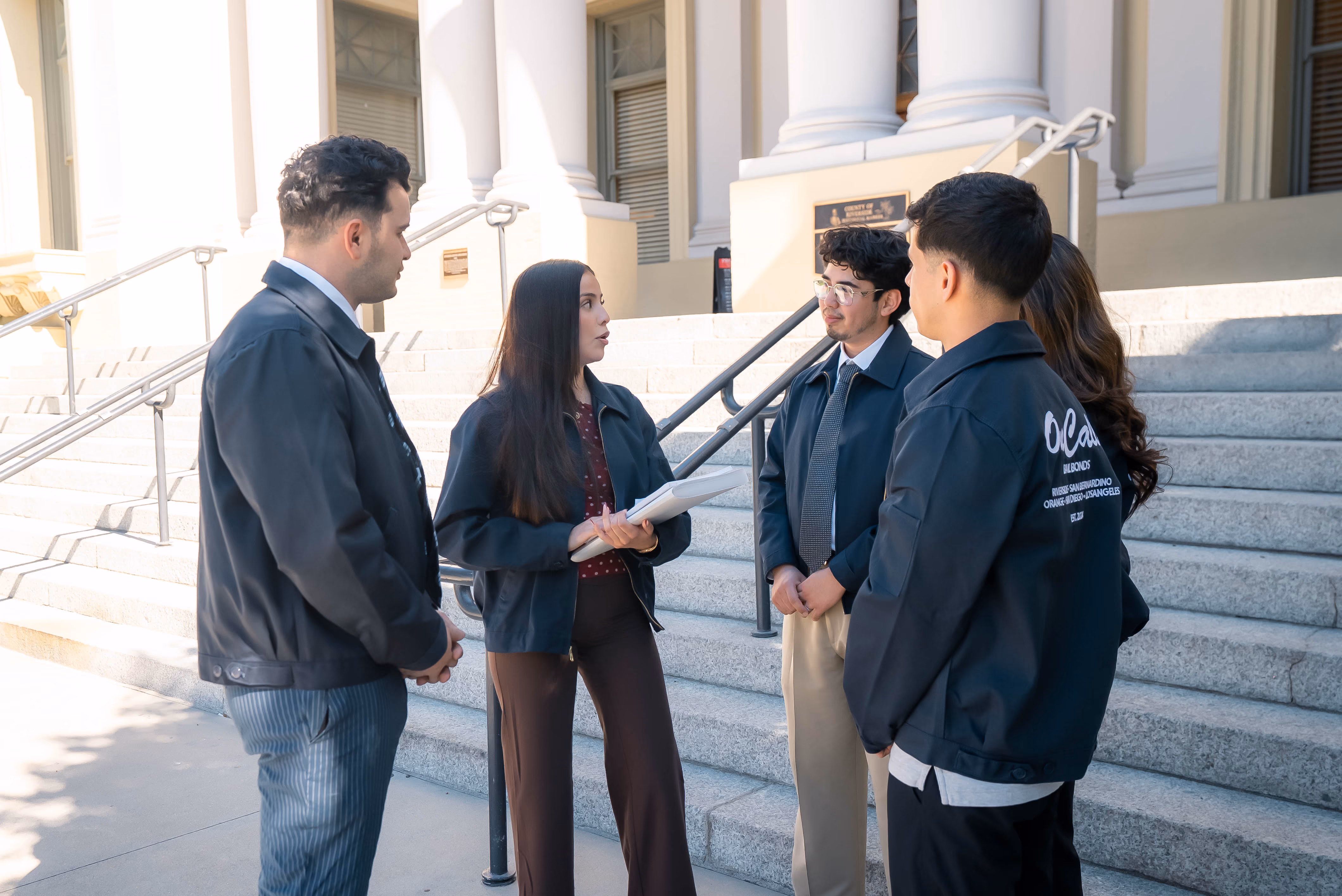 OnCall Bail Bonds agents meeting on the courthouse steps