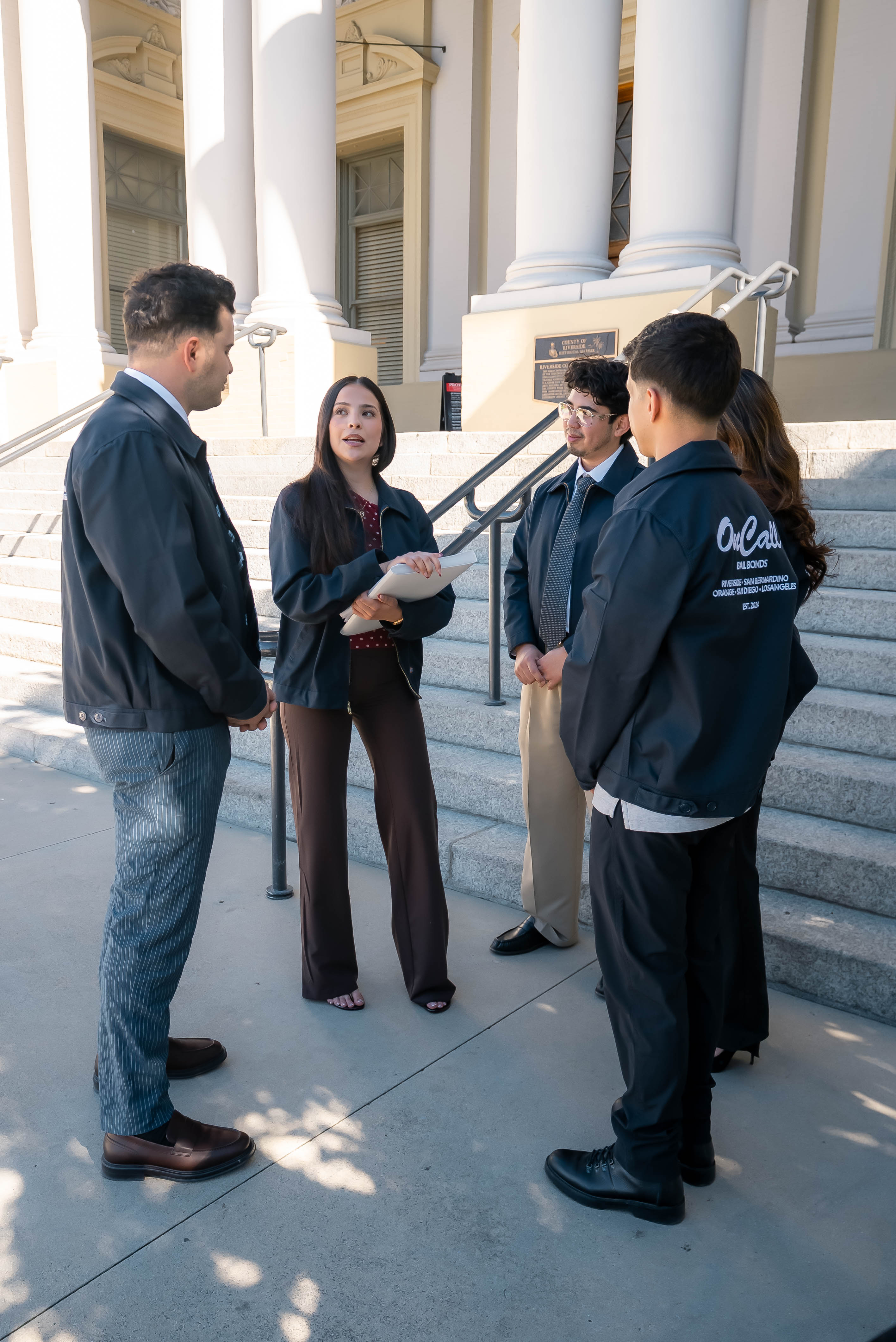 OnCall Bail Bonds agents talking on the steps of the Riverside County courthouse