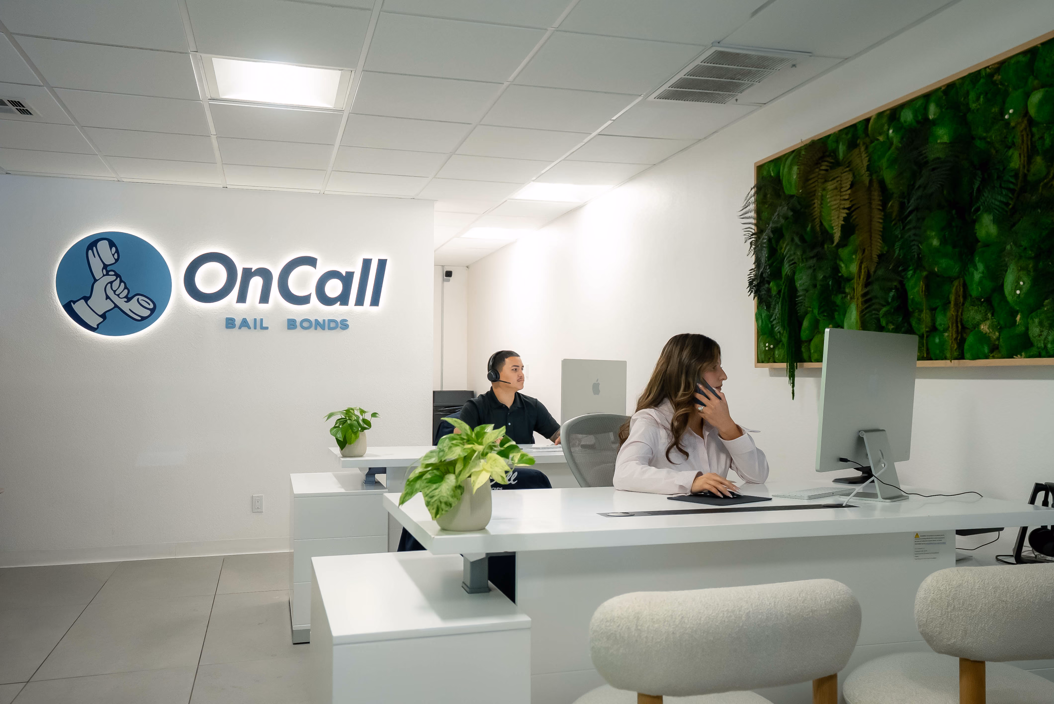 Inside an OnCall Bail Bonds office, with agents working at their desks