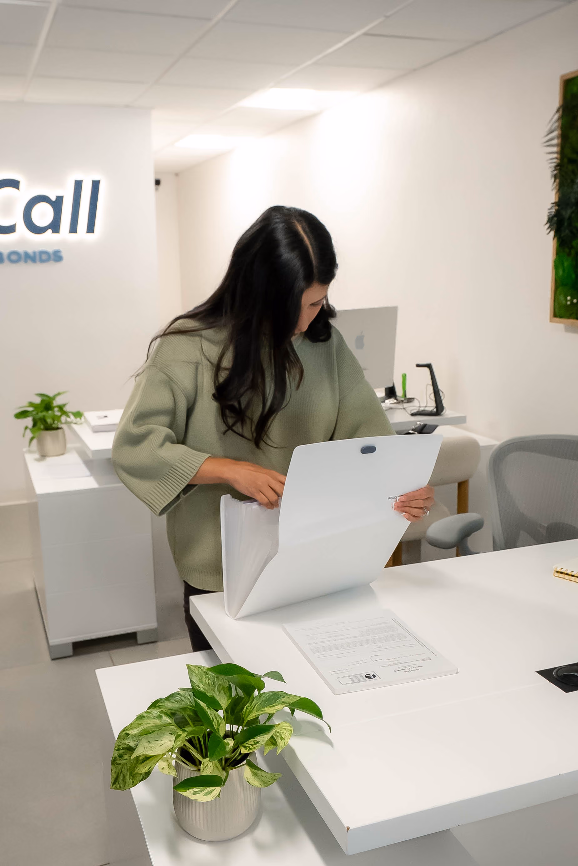 Agent reviewing paperwork at an office desk