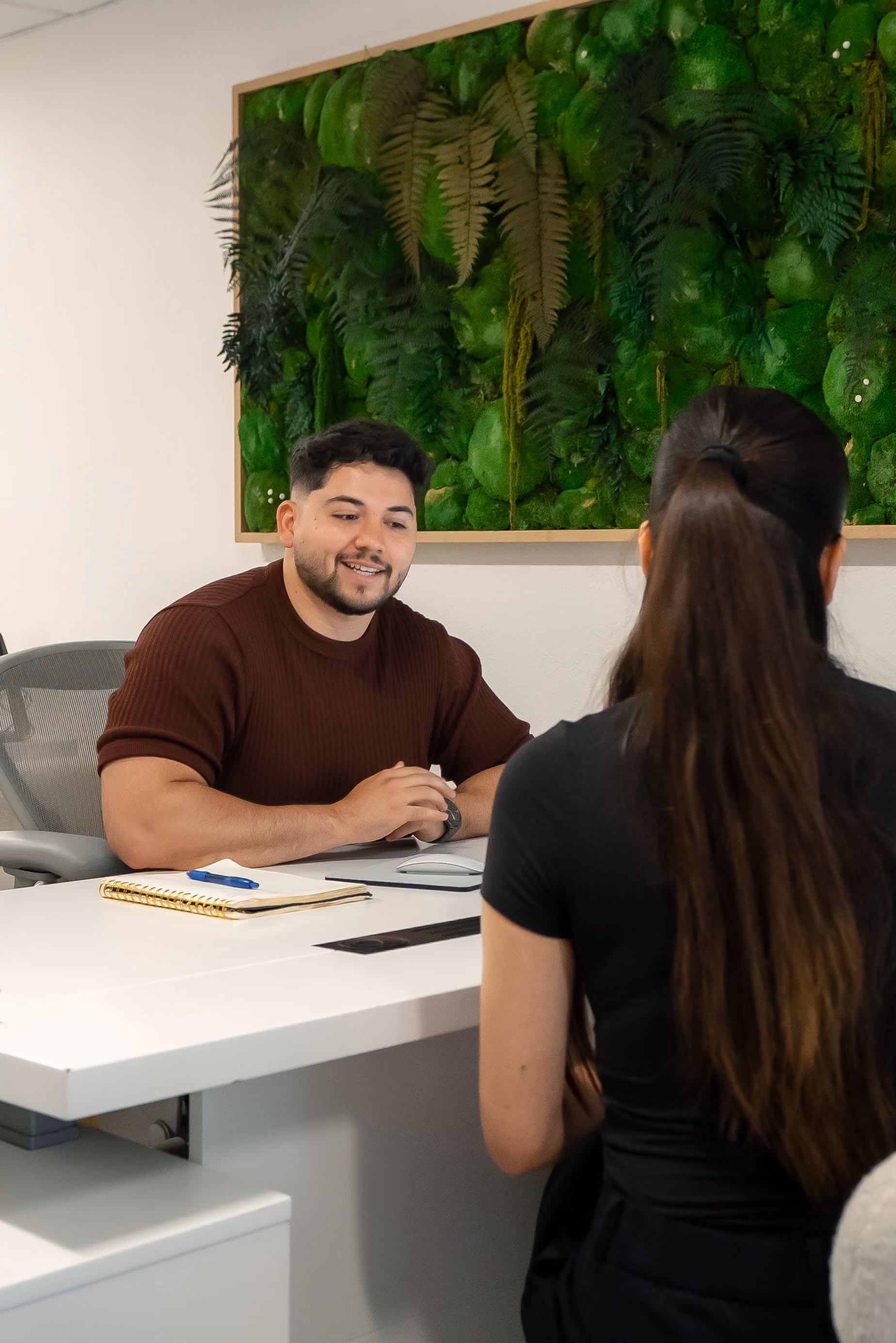 Bail agent meeting with a client across an office desk