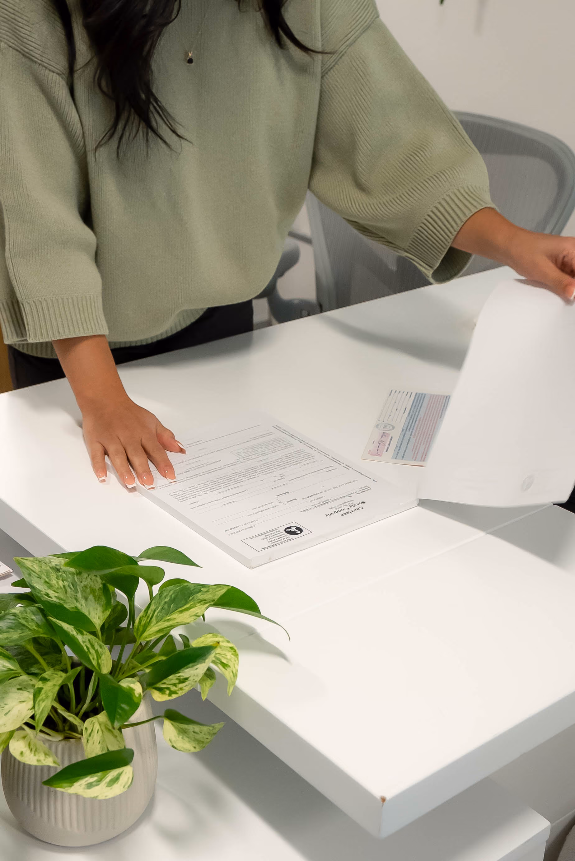 Agent laying out paperwork on an office desk
