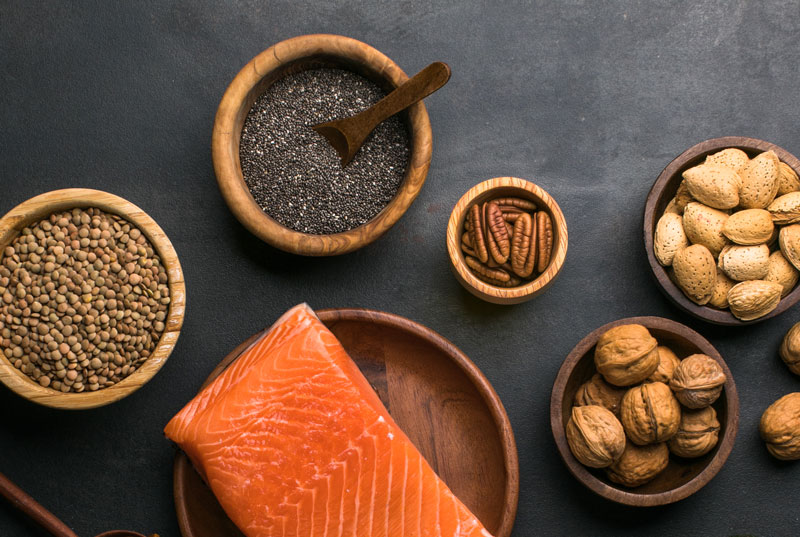 Phono of Salmon, nuts and seeds on a dark background.