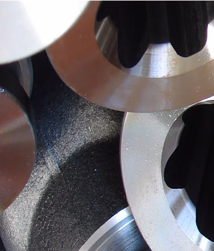 Close-up of metal circular parts with smooth edges stacked together.