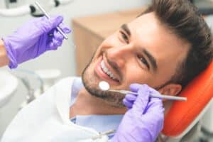 Young man in a dental chair after a root canal in Ashland, OH