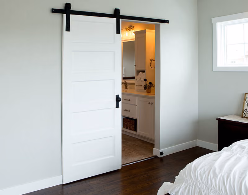 SMSA5 Primed Molded Door with Black Barn Door Hardware and Track Beauty Shot