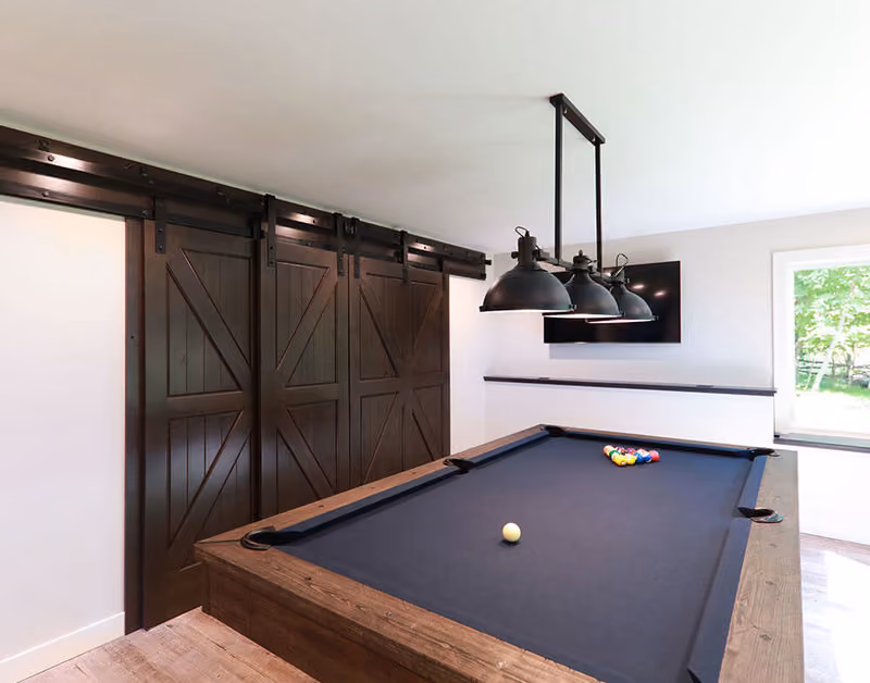PAKCK Knotty Alder Door with Black Barn Door Hardware and Track Beauty Shot