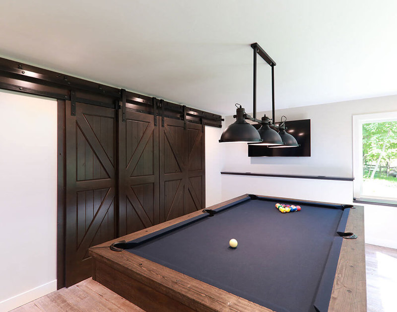 PAKCK Knotty Alder Door with Black Barn Door Hardware and Track Beauty Shot