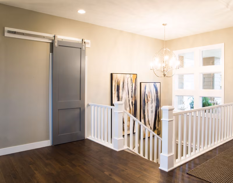 S.O. 8ft Door with 176A Primed Casing, 239A Primed Base, Silver Barn Door Track and Hardware, 4091 Primed Box Newel, 5360 Primed Baluster and 6770 Rail  Beauty Shot