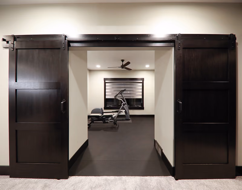 PPOE3 Poplar Interior Door with Black Barn Door Hardware and Track Beauty Shot
