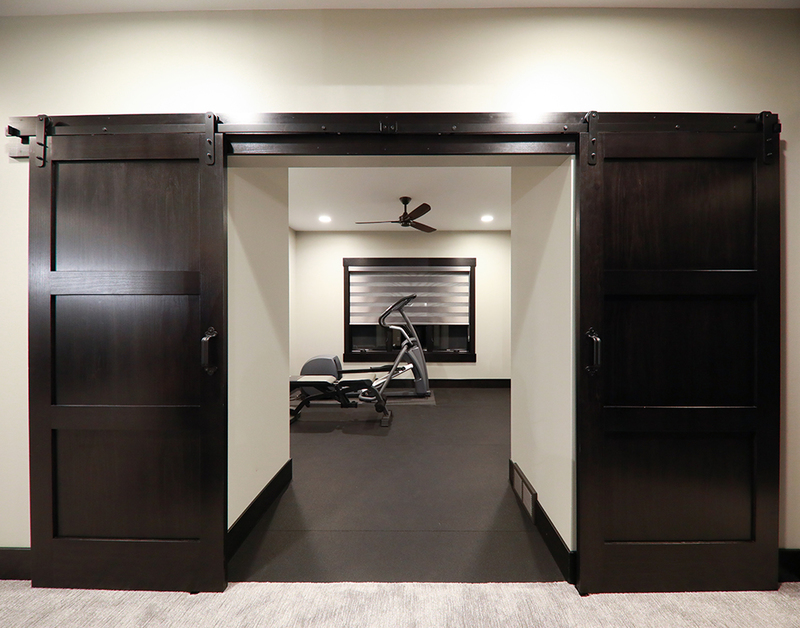PPOE3 Poplar Interior Door with Black Barn Door Hardware and Track Beauty Shot