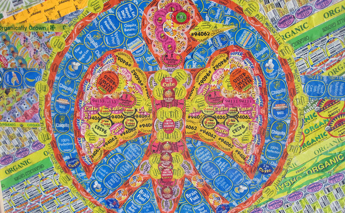 Pineapple shape made from colorful fruit stickers including Chiquita, Cutie, and organic labels.