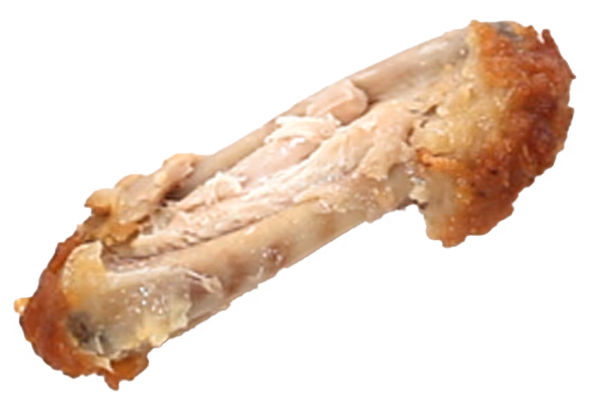 Partially eaten fried chicken wing with visible bones and some remaining meat on a white surface.
