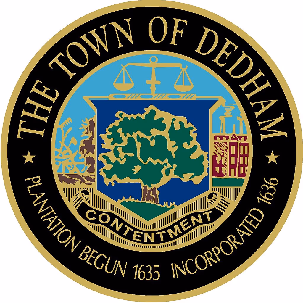 Seal of the Town of Dedham with a central tree, scales of justice, and industrial and agricultural symbols, surrounded by text noting plantation began 1635 and incorporated 1636.