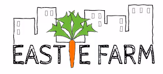 Logo with the words 'EASTIE FARM' featuring a carrot with green leaves replacing the letter 'I', with simple city buildings in the background.