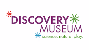 Discovery Museum logo with colorful starburst icons and the tagline science, nature, play.