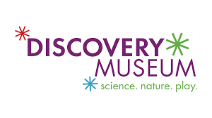 Discovery Museum logo with colorful starburst icons and the tagline science, nature, play.