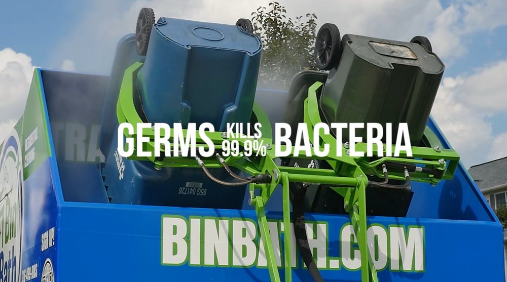 Two garbage bins mounted upside down on a blue and green washing machine with text stating 'Germs kills 99.9% bacteria'.