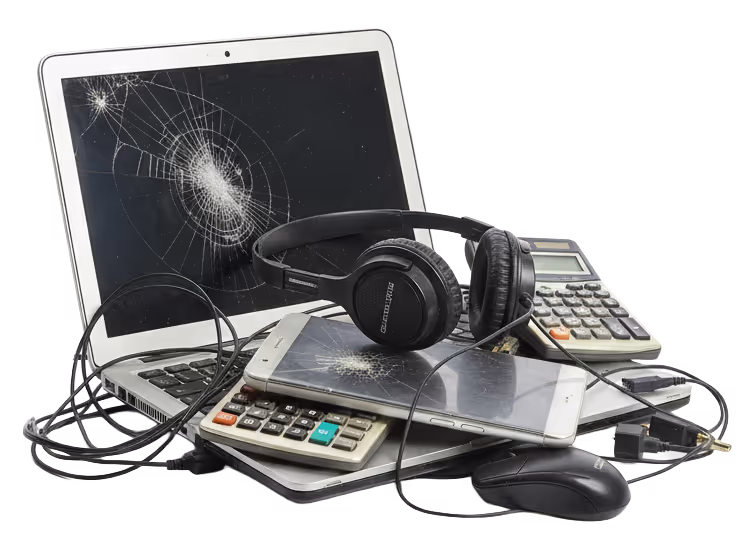 A pile of broken electronics including a laptop and smartphone with cracked screens, headphones, calculators, and a computer mouse.