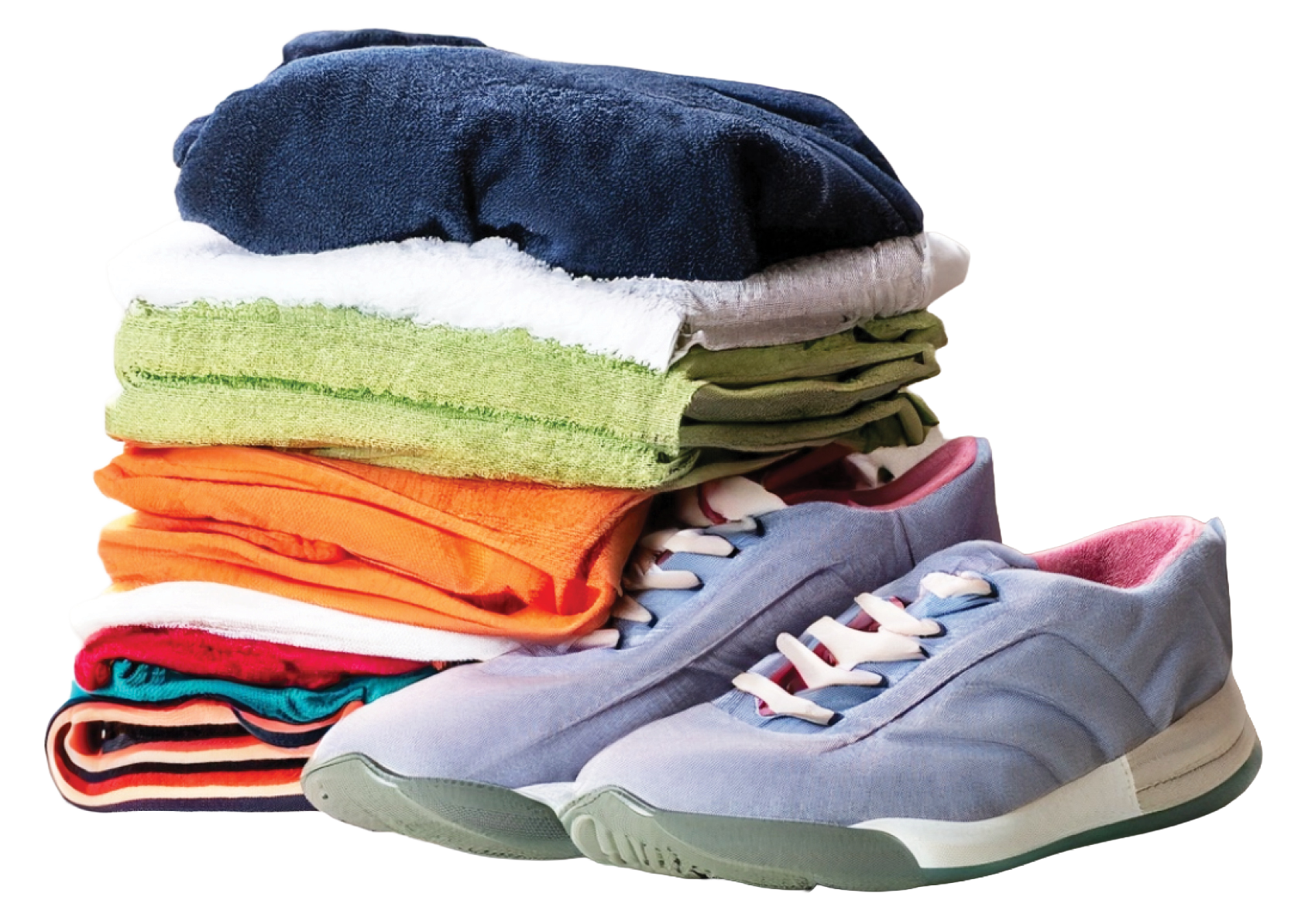 Stack of colorful folded towels next to a pair of light purple sneakers with white laces and pink interior.