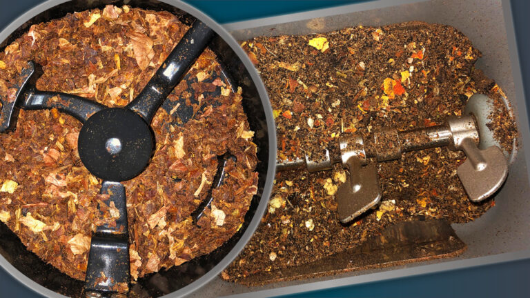 Close-up of a composting machine's interior showing decomposing organic material and the mixing blades.