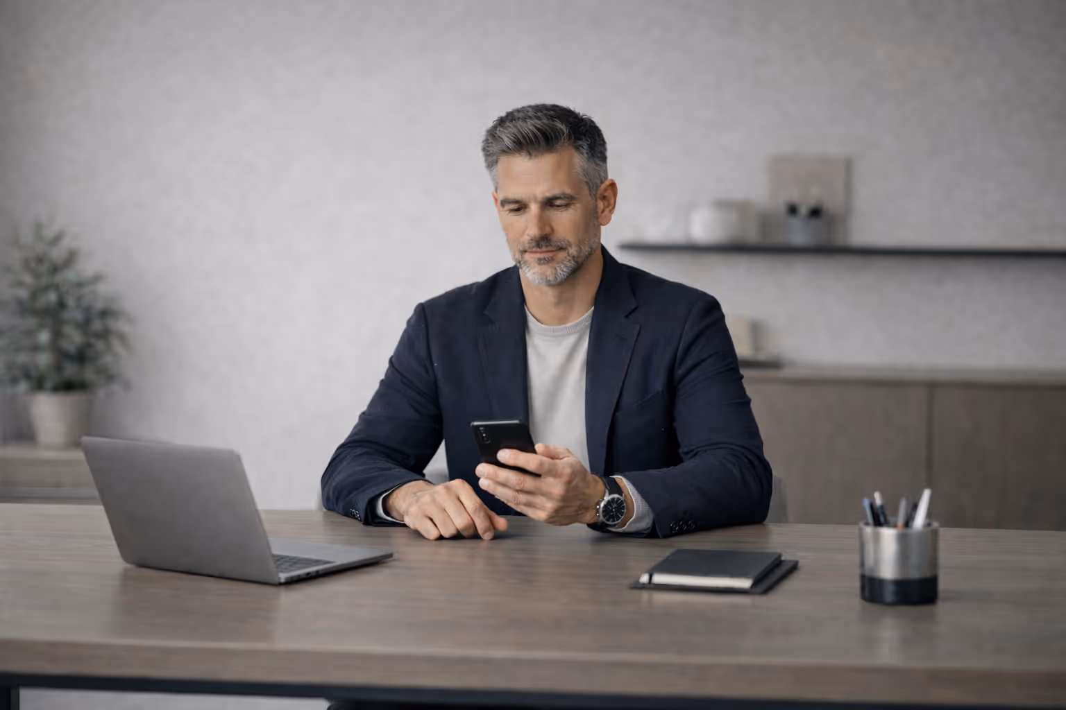 Woman staring down at papers strewn across her kitchen table, visibly stressed about budgeting.