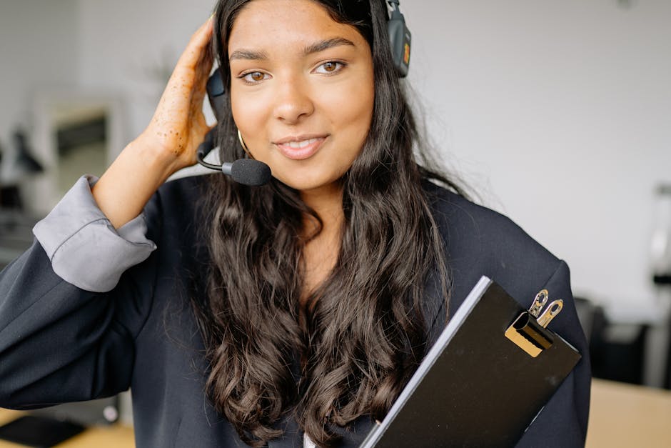 friendly call center agent with a headset on, in a professional setting - What are the best call center outsourcing services that can help a small home service business scale up its operations?