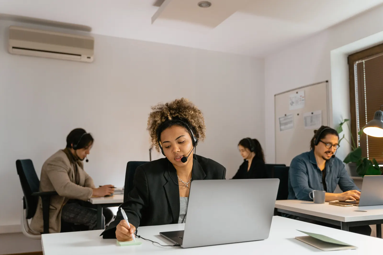 busy HVAC dispatcher scheduling service calls in a professional office - contractor performance metrics