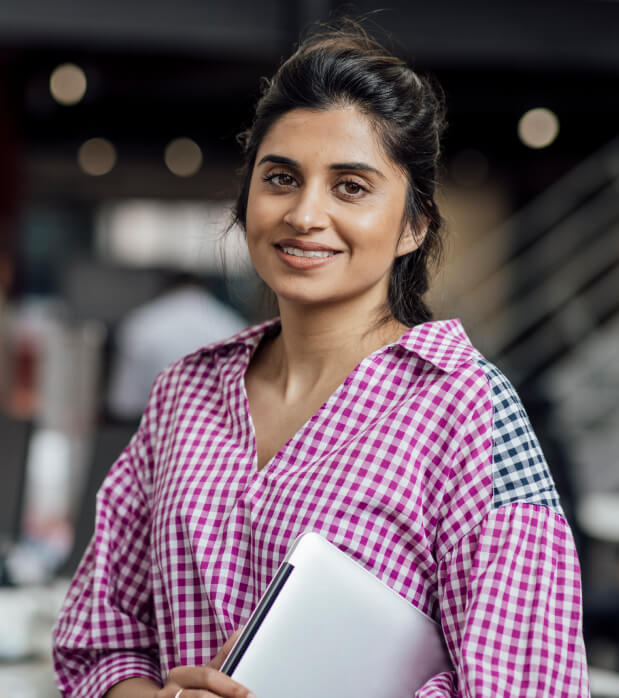 "Smiling professional, representing a financial team member, holding a laptop in a modern office environment. Highlights Onso's benefit in transforming procurement with automation, seamless Xero integration, and streamlining invoice matching.