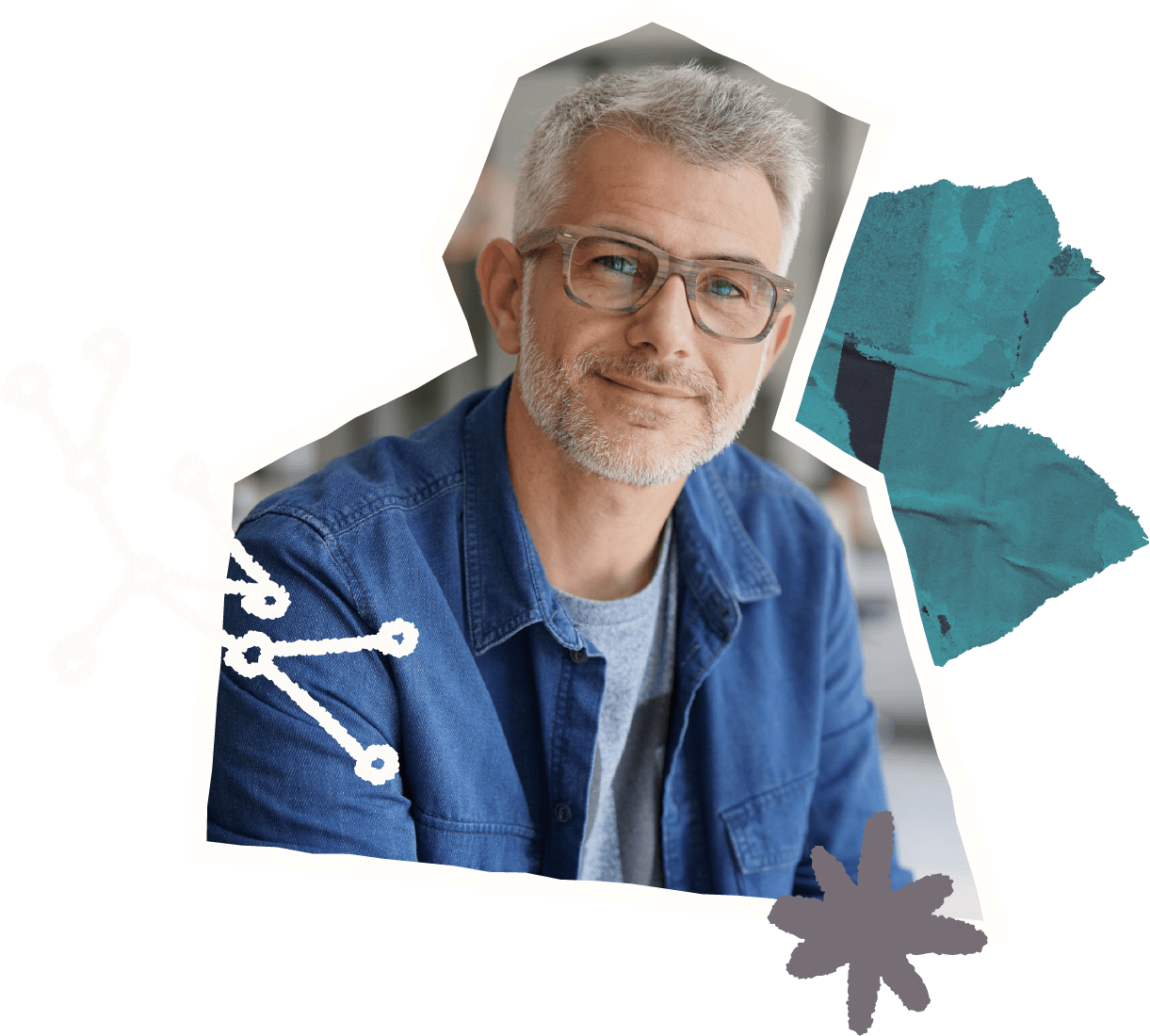 Smiling middle-aged man with gray hair and beard wearing glasses and a blue denim shirt.