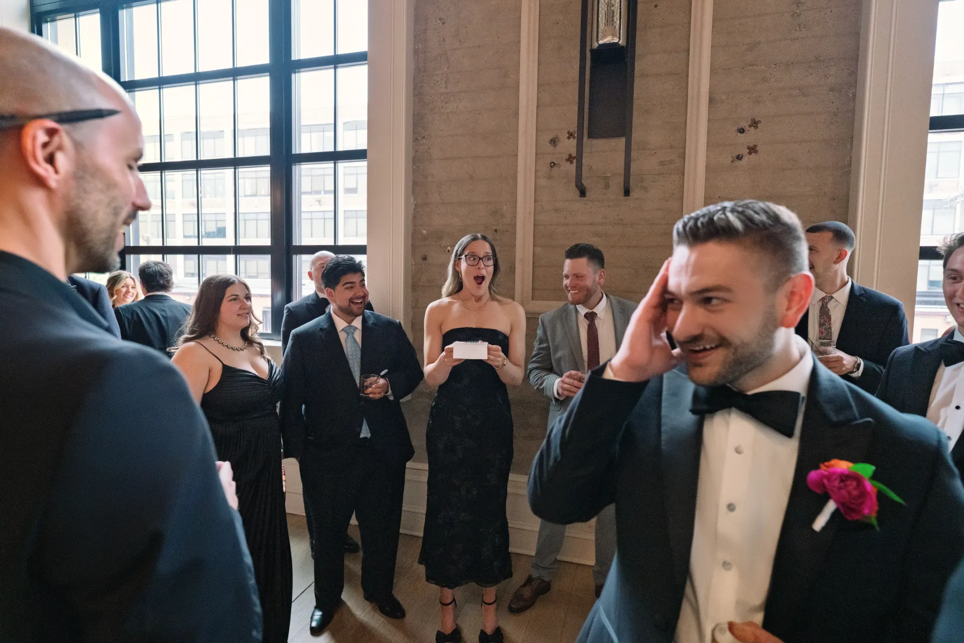 Guests smiling during a wedding magic performance at The Switch House by Cescaphe