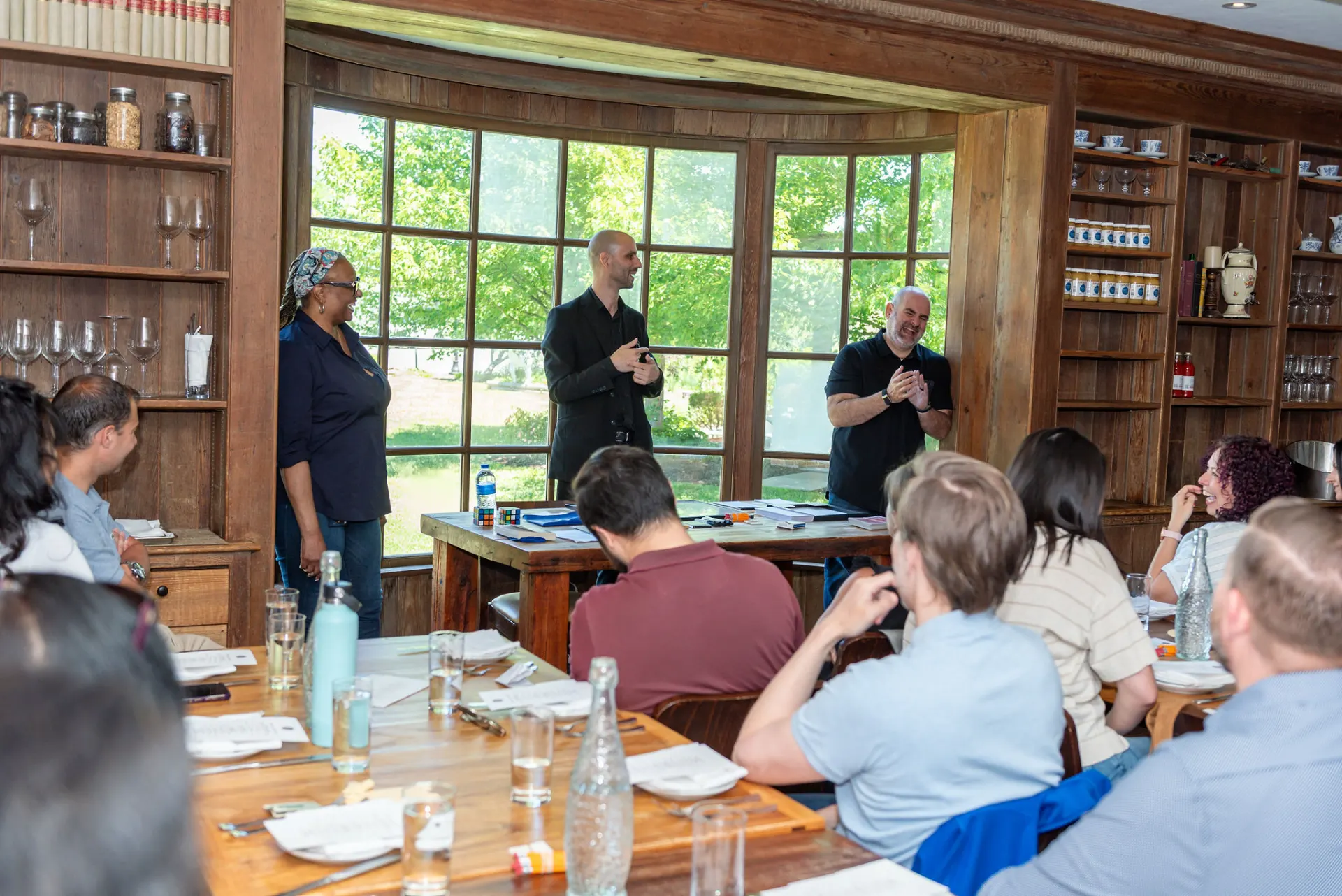 Otsuka Pharmaceutical team members reacting during Jesse Dameron’s comedy magic performance at Brick Farm Tavern.
