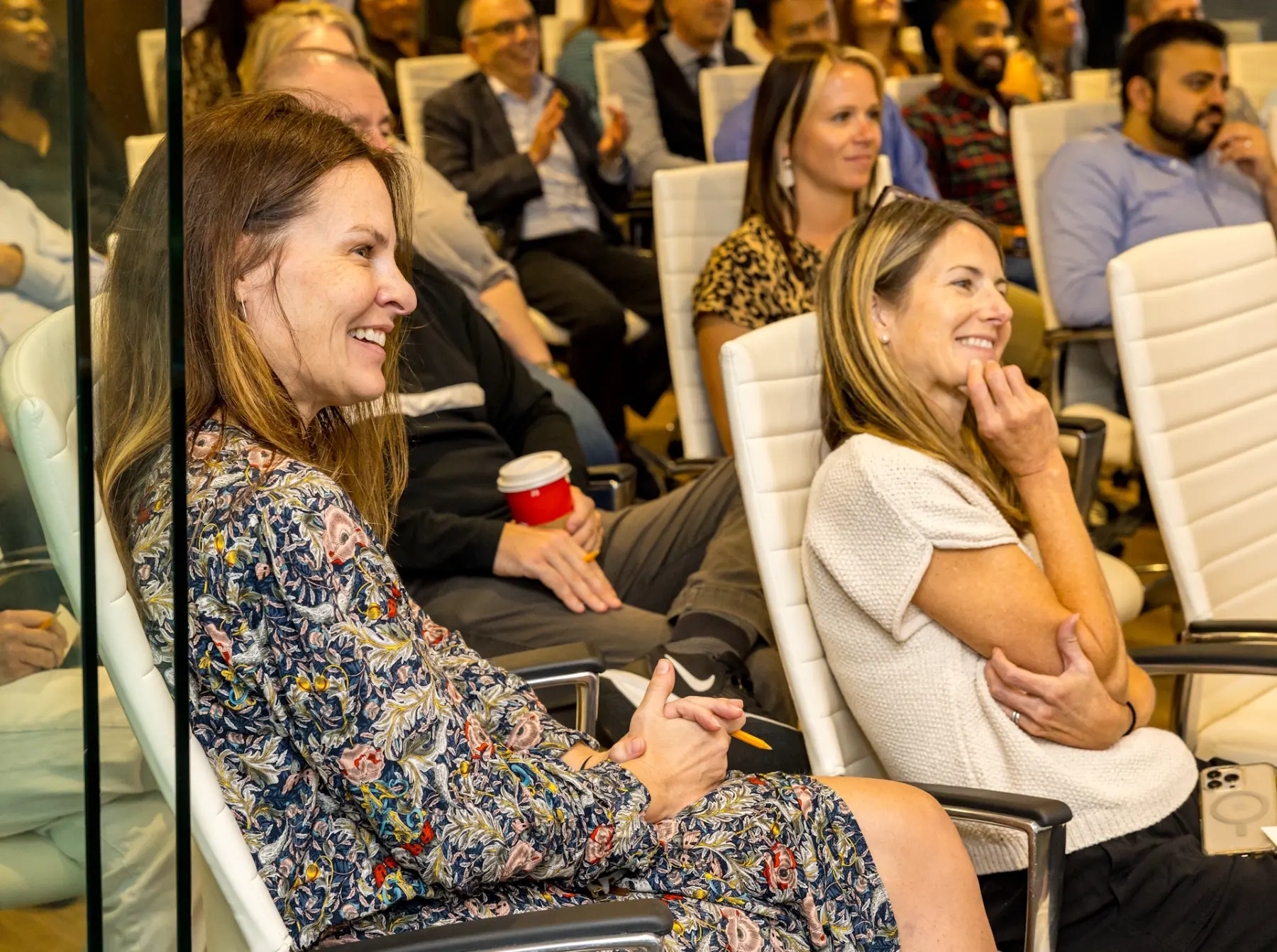 Two attendees react and smile during comedy magic