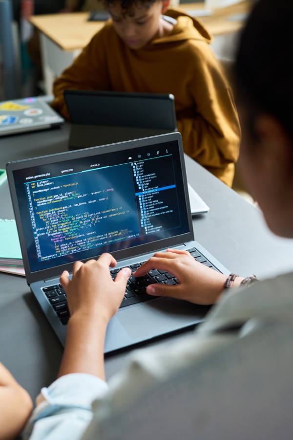 Hands of business people pointing and discussing charts and graphs on printed reports at a desk.